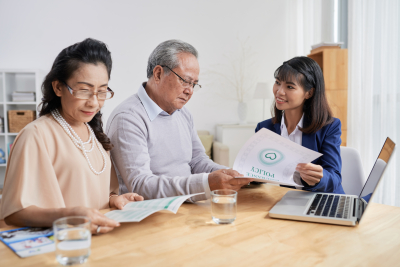 senior couple having a discussion with a young woman