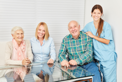 senior couple with two young women